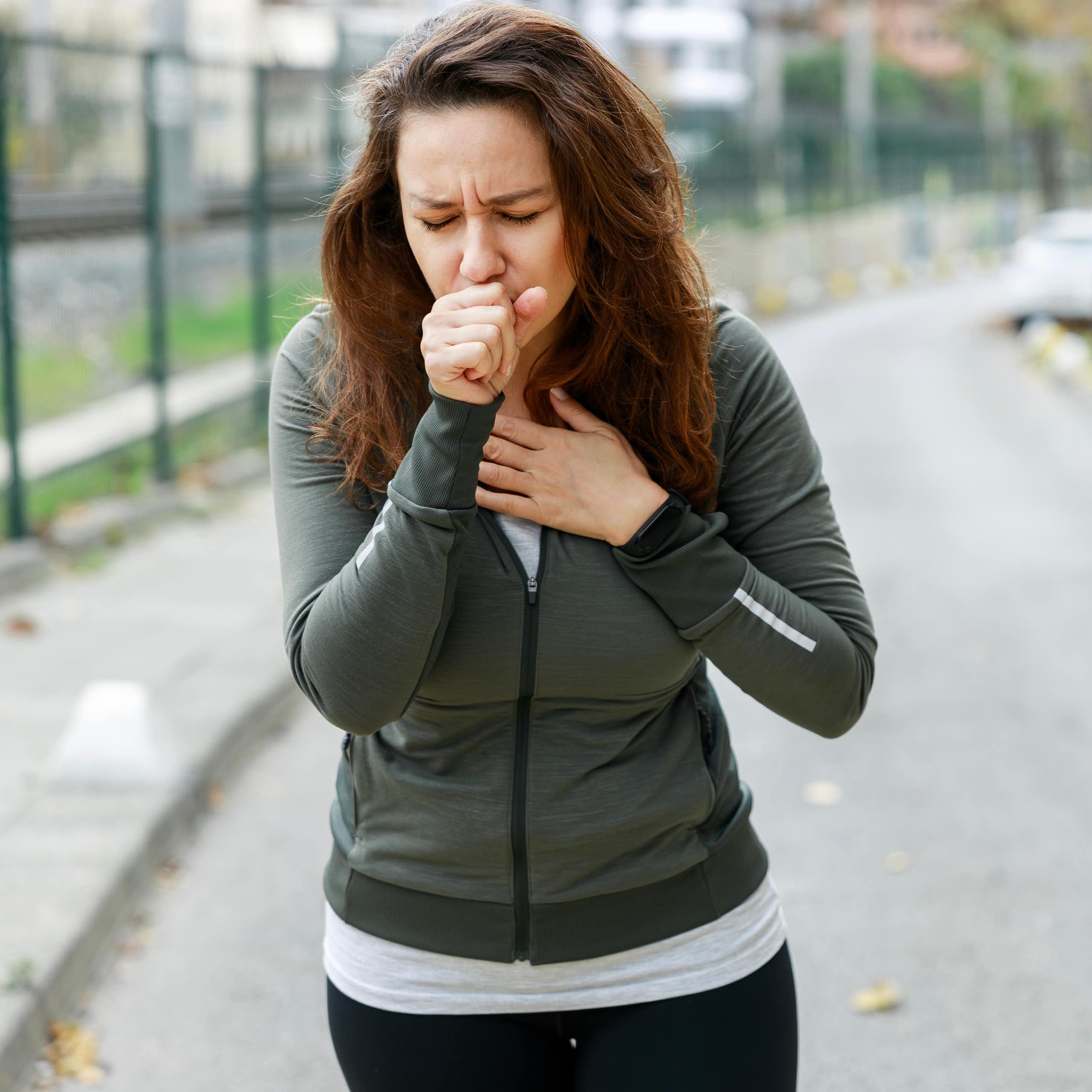 woman running coughing pollution