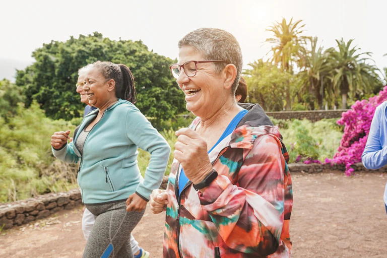 A group of older women running outdoors.