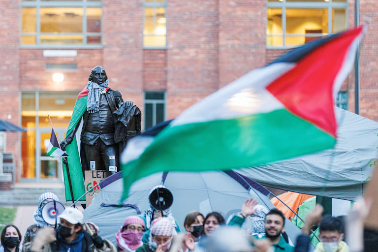 A large Palestinian flag and students protesting.