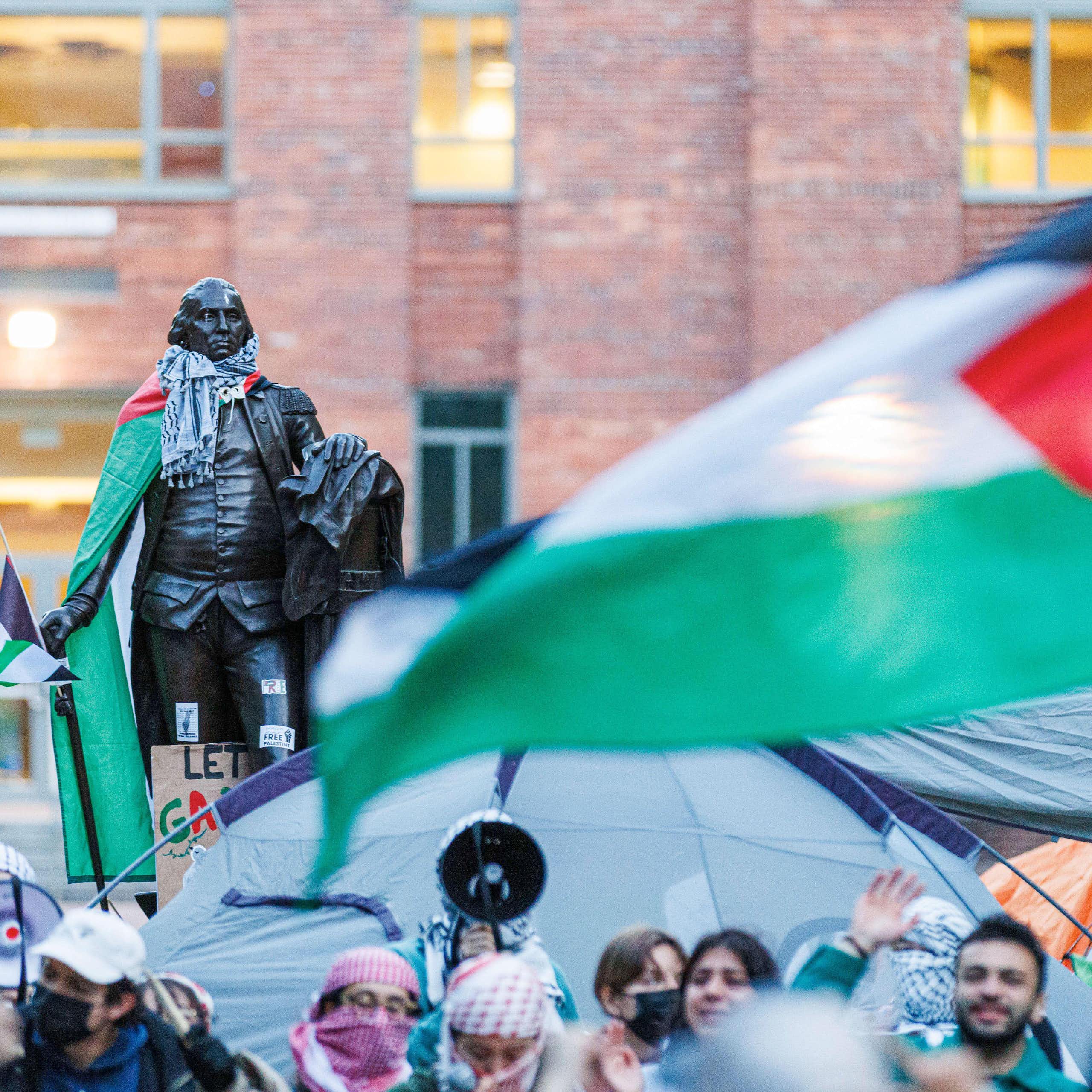 A large Palestinian flag and students protesting.