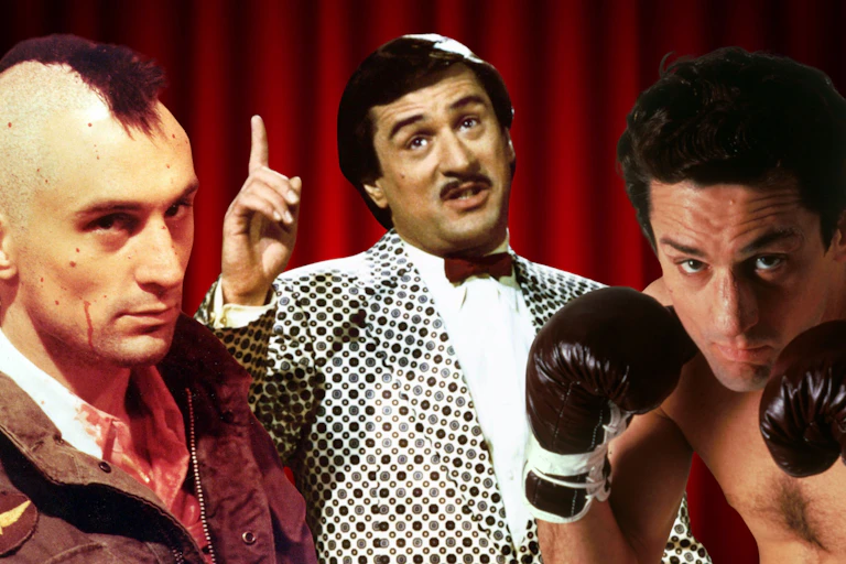 Robert De Niro with a mohawk, in a bright patterned suit and wearing boxing gloves.
