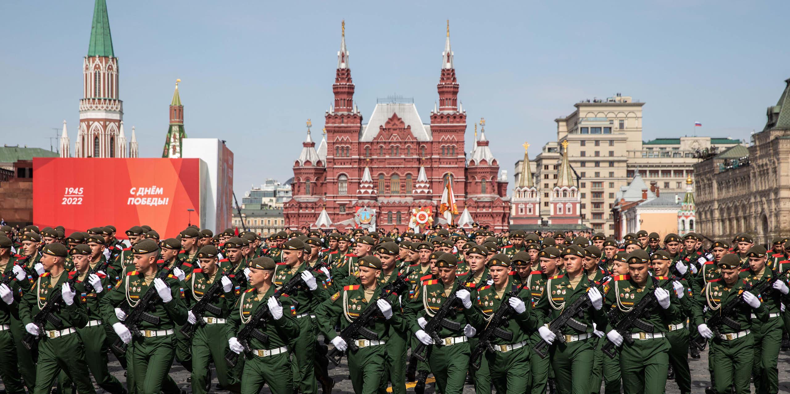 Soldiers in green, with Red Square buildings in background.