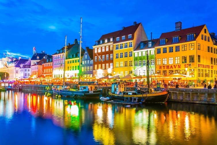 An evening view of colourful, waterside houses in Copenhagen.