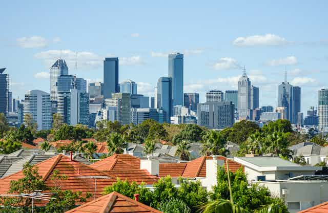 Melbourne skyline seen in distance behind suburban rooftops
