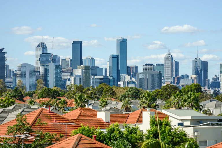 Melbourne skyline seen in distance behind suburban rooftops