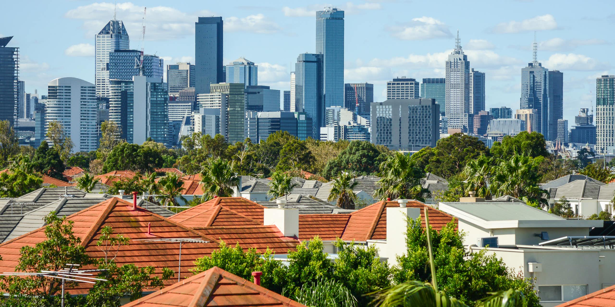 Melbourne skyline seen in distance behind suburban rooftops