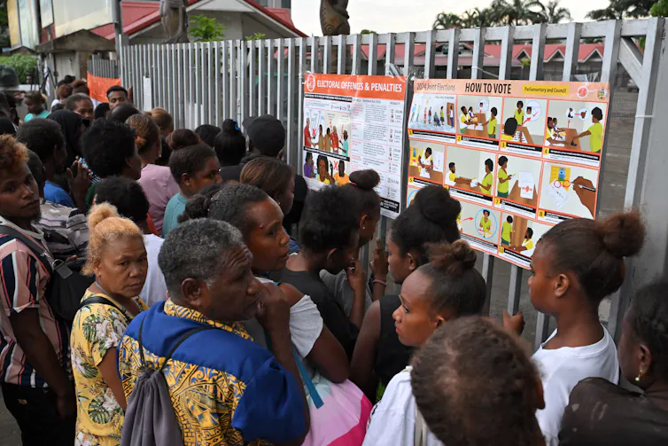 Voters waiting for a polling station to open.
