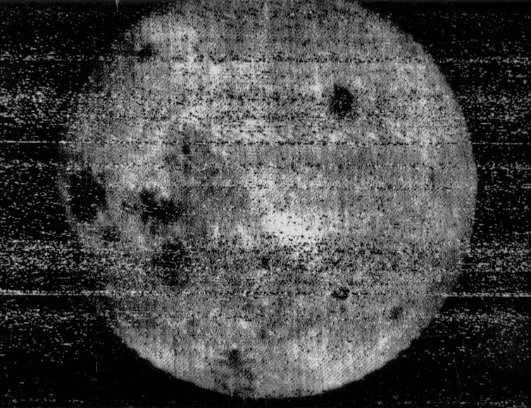 A pixellated image of the Moon showing several dark pockmarks on the surface.