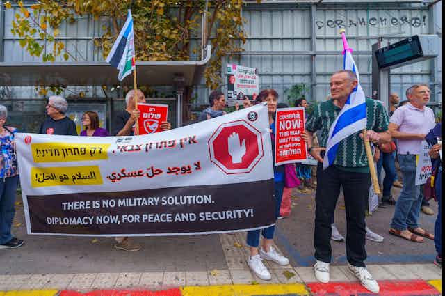 People with signs calling for peace talk, ceasefire and hostage deal, part of a protest march, Haifa, Israel 
