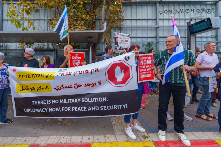People with signs calling for peace talk, ceasefire and hostage deal, part of a protest march, Haifa, Israel