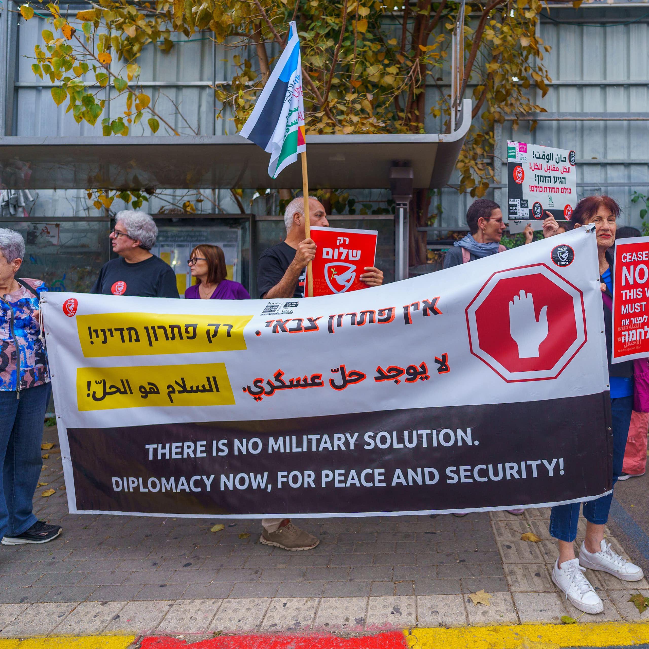 People with signs calling for peace talk, ceasefire and hostage deal, part of a protest march, Haifa, Israel 