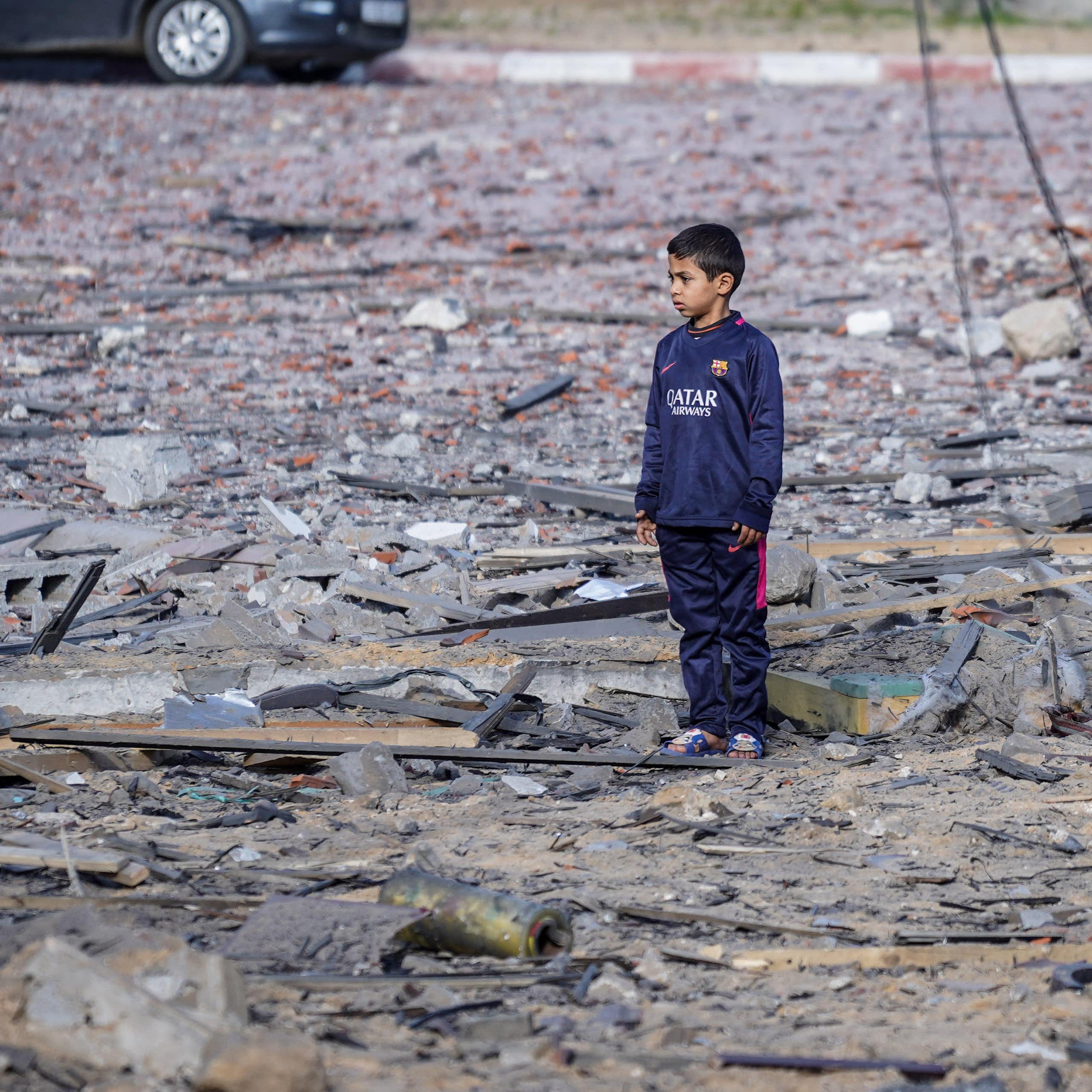 A child standing alone surrounded by rubbleA child seen standing alone surrounded by rubble.