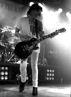 Man on stage playing guitar