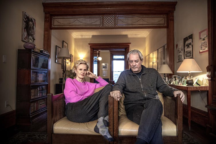A middle-aged couple sitting on a sofa in their elegant living room.