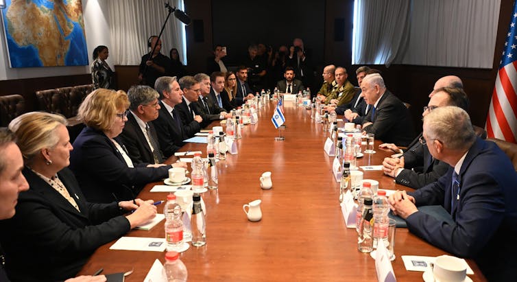 US secretary of State Blinken meeting Israeli prime minister Netanyahu and their teams around a long table during talks in Jerusalem.