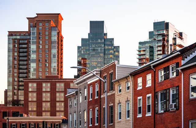 Baltimore rowhouses are juxtaposed with skyscrapers.