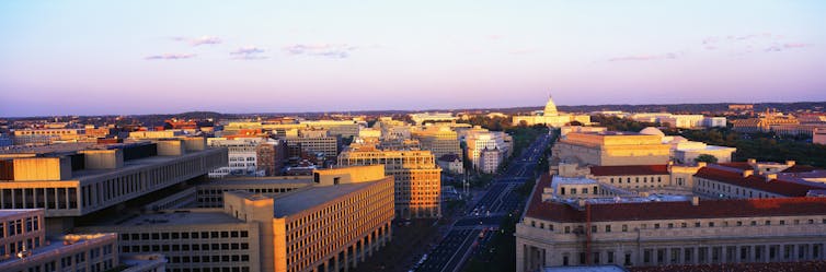 An aerial view of a lot of large buildings in a city.
