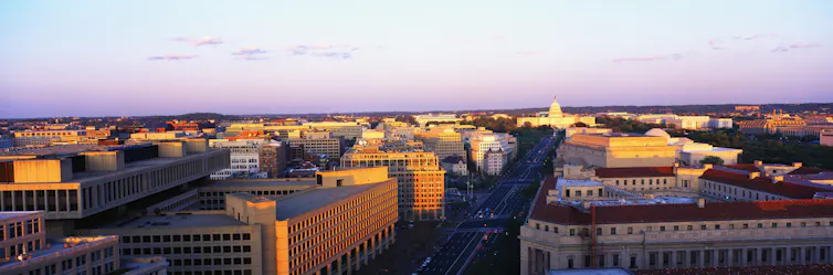 An aerial view of a lot of large buildings in a city.