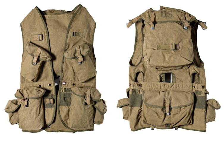 A brownish green vest with many pockets and straps.