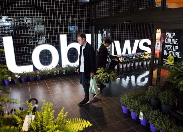 A man walking out of a Loblaws store