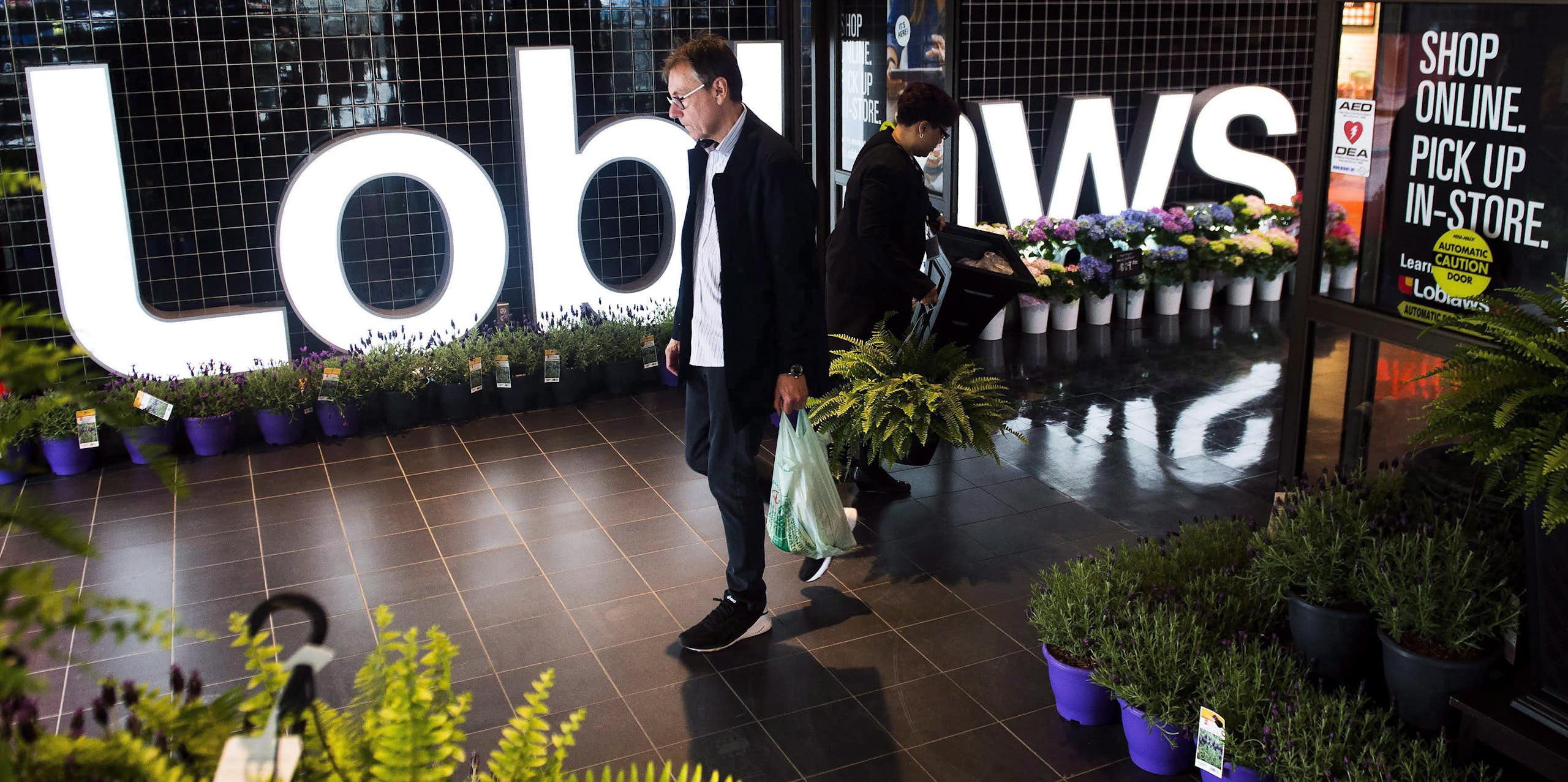 A man walking out of a Loblaws store