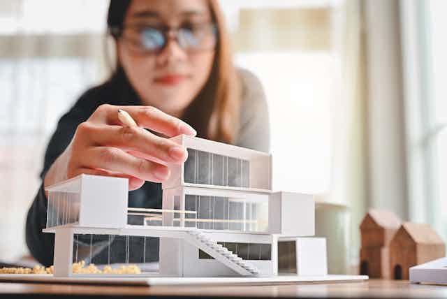Woman builds an architectural model
