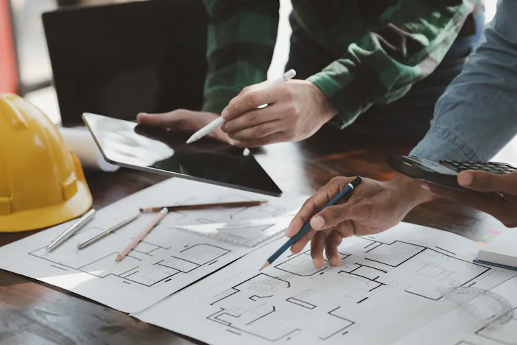 Architects look over plans.