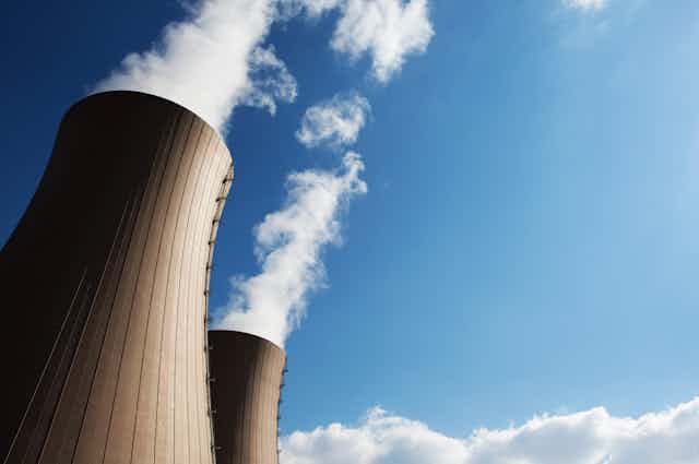 Two cooling towers of nuclear power plant against the blue sky