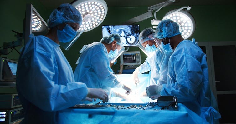 Surgeons performing a heart transplant