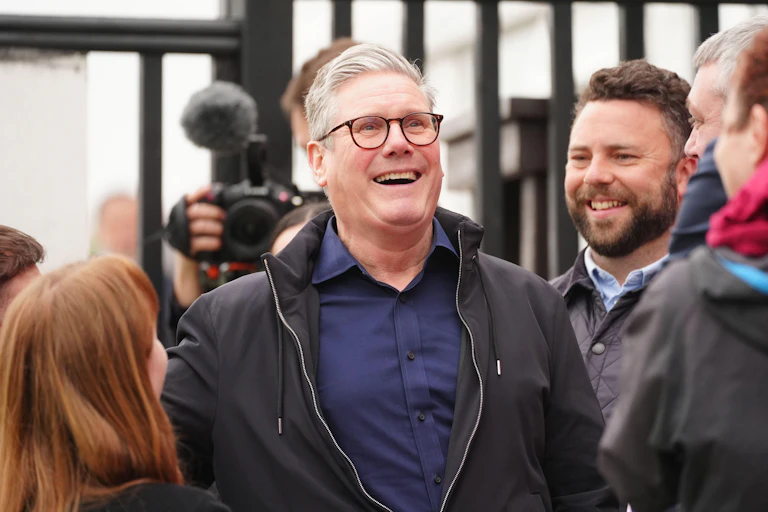 Keir Starmer laughing in a crowd.