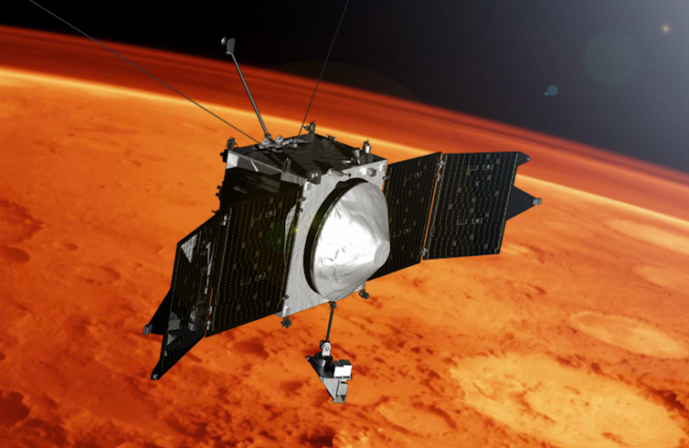 A spacecraft that looks like a metal box with two solar panels attached on either side and a small limb extending downward.