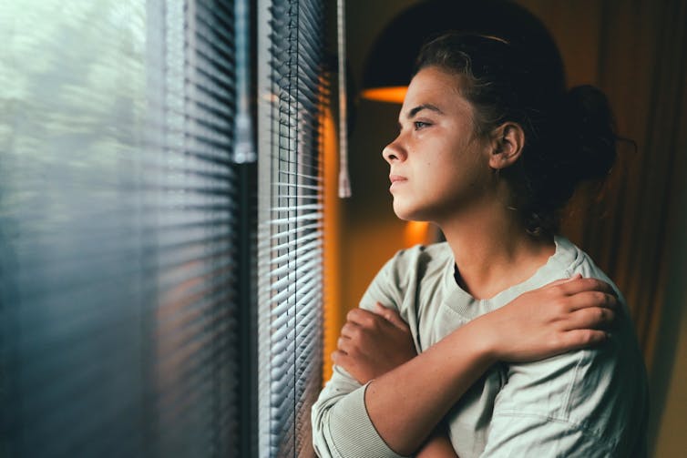 Pregnant woman looking out a window