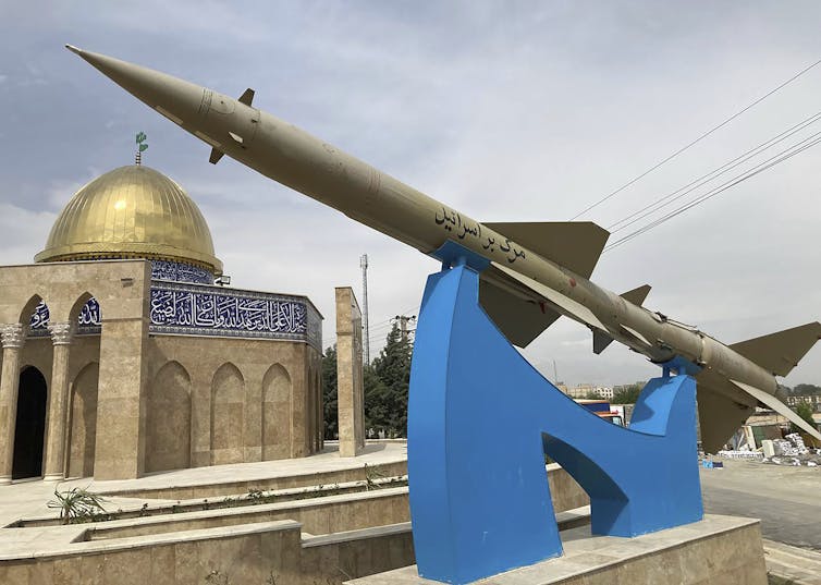 A missile on display with a sign reading