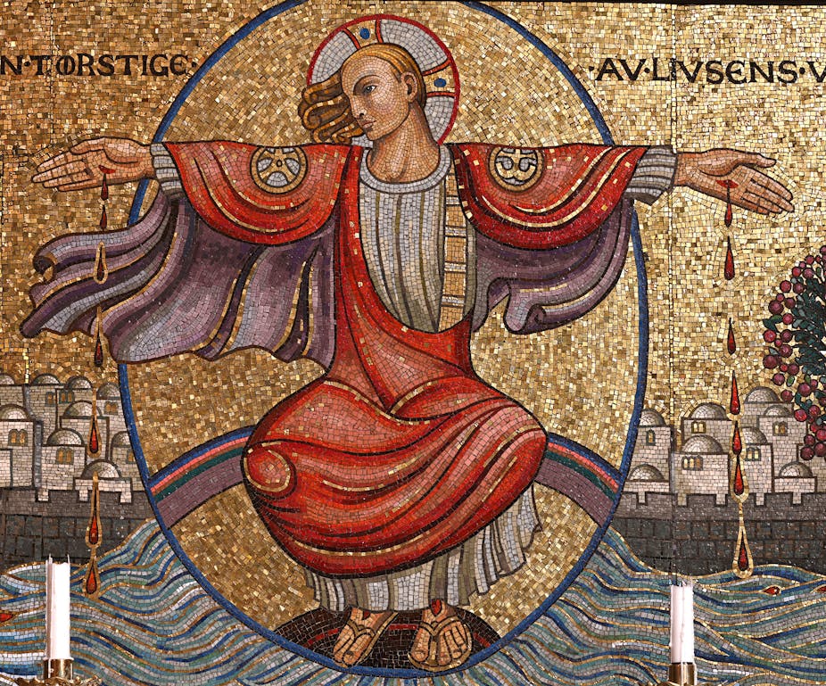 A painting of a man with hands stretched out, halo around his head, wearing a red and purple color gown.