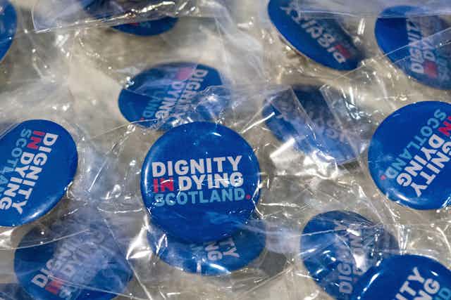 Blue buttons with the words 'Dignity in Dying Scotland'
