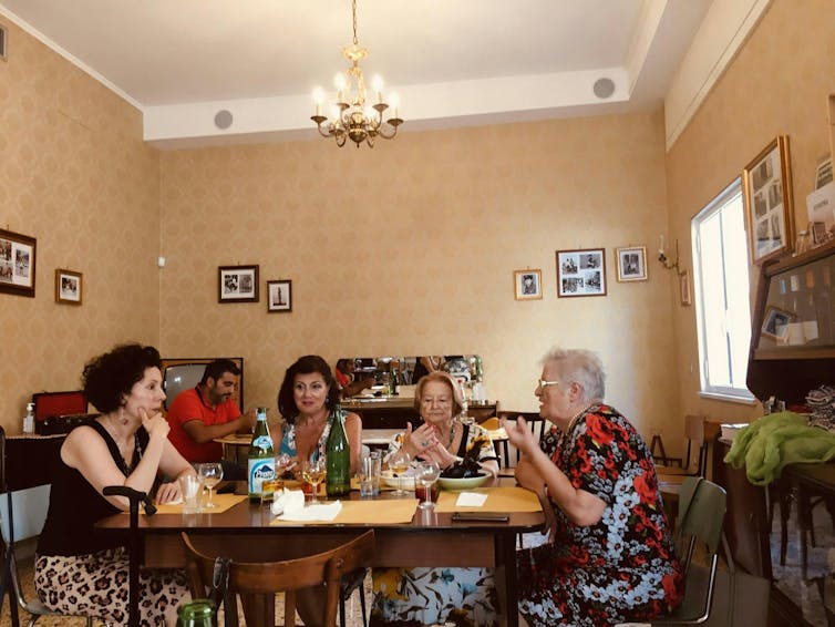 A group of women eating, at a family table