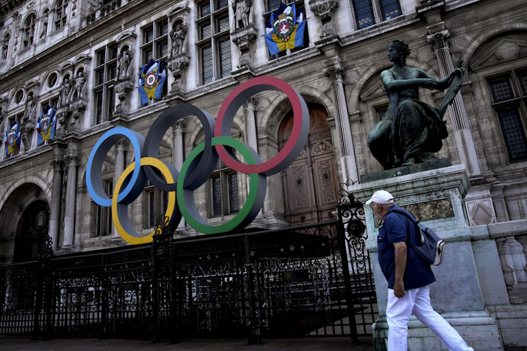 The multi-coloured Olympic rings in front of an old european building