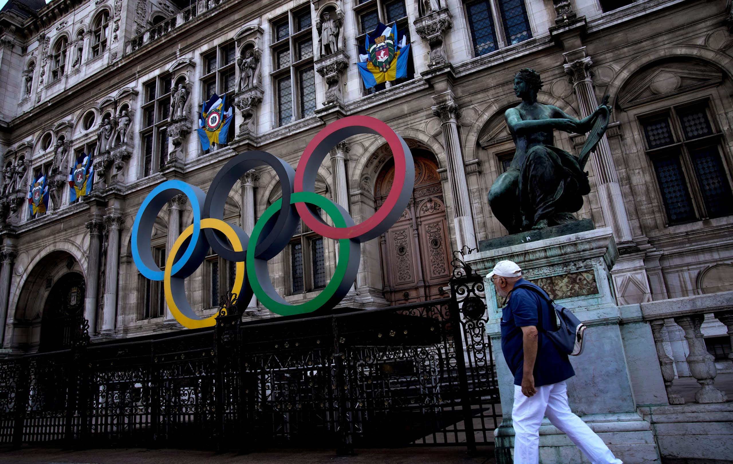 The multi-coloured Olympic rings in front of an old european building
