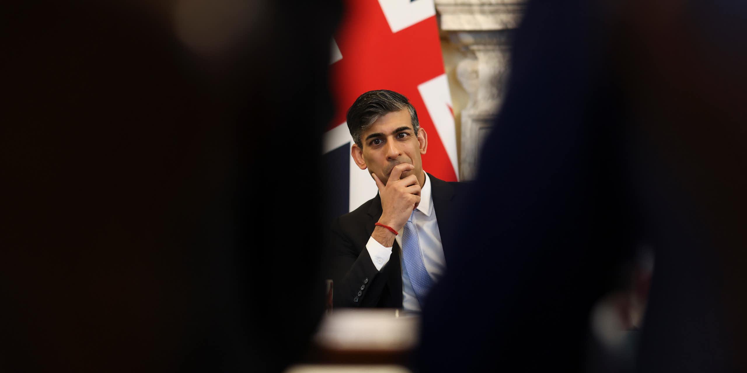 Rishi Sunak sitting in front of a union flag
