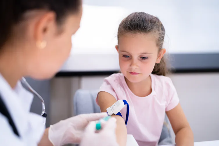 A girl gets a blood test.