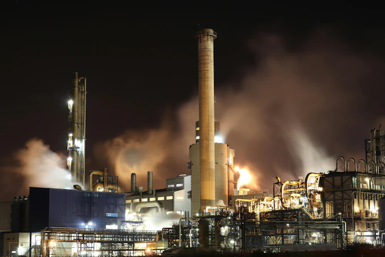 Industrial site with smog billowing from its chimneys