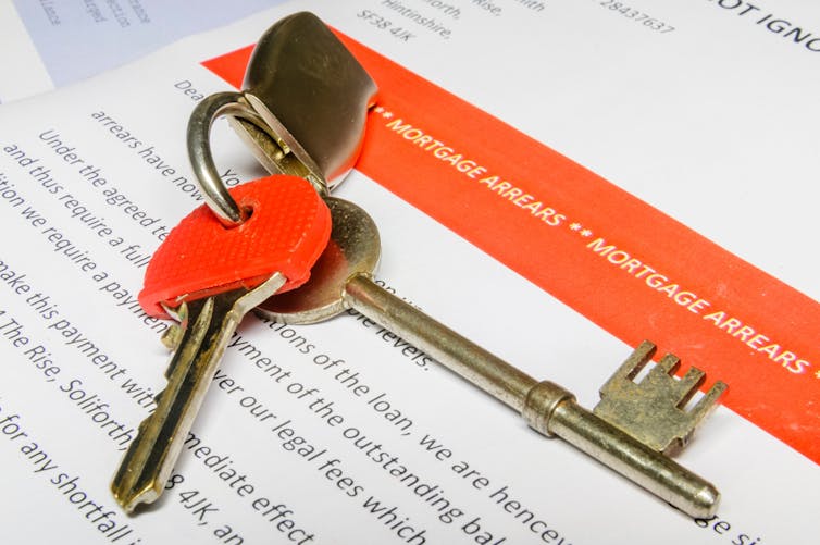 House keys sitting on a letter informing of mortgage arrears