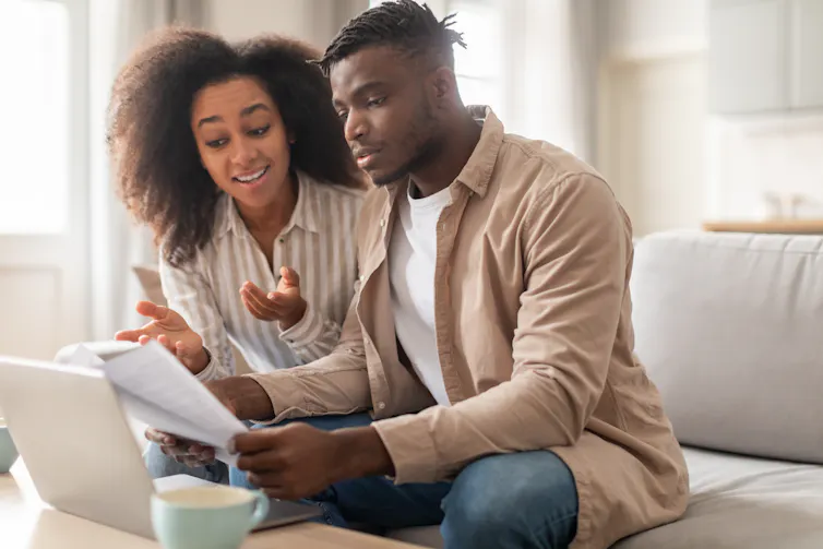 A young couple looking at some documents