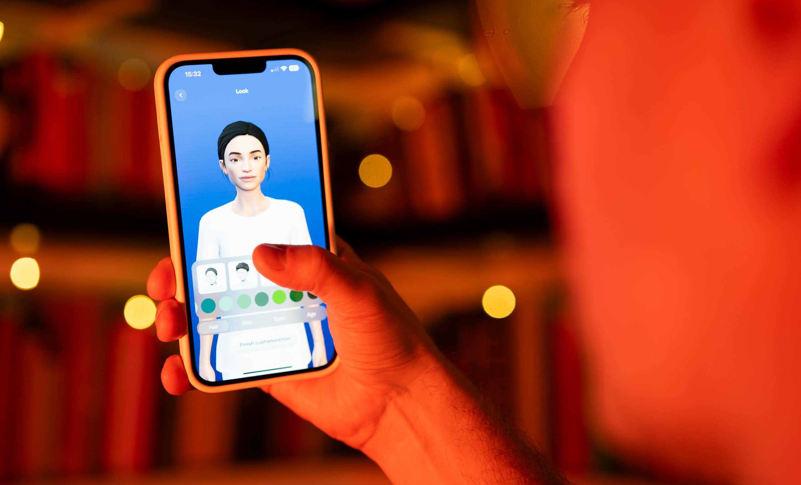  photo shows a user interacting with a smartphone app to customize an avatar for a personal artificial intelligence chatbot
