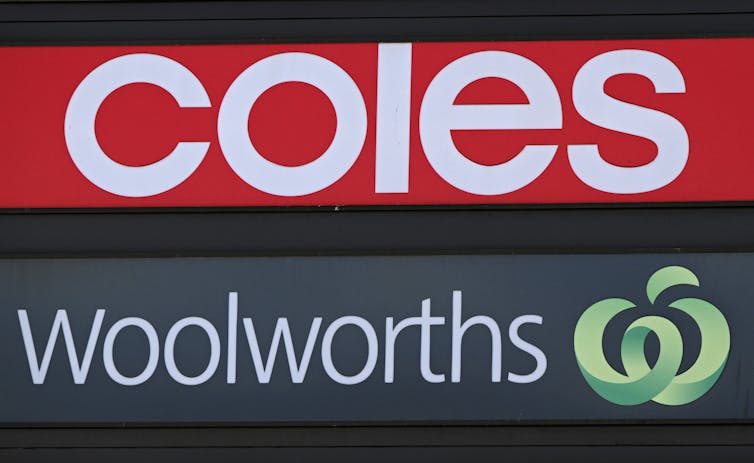 Storefront signs saying 'Coles' and 'Woolworths'
