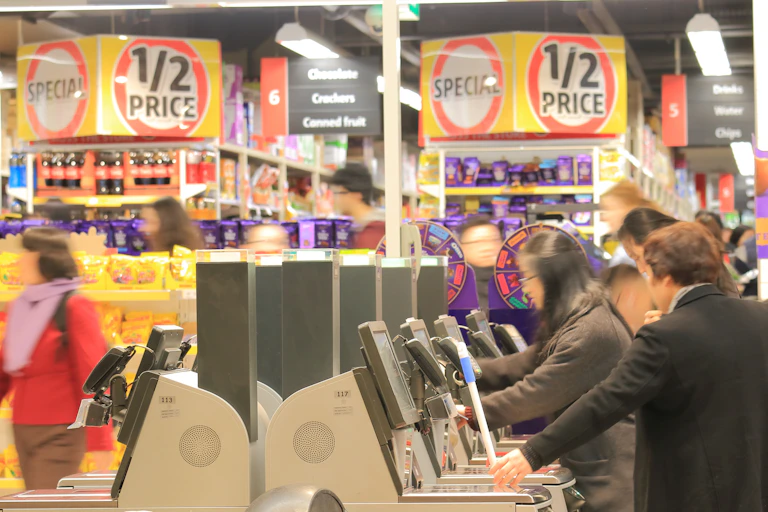 Unidentified people use self check out at a supermarket.