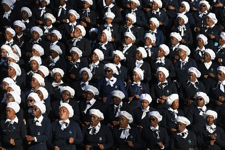 A mass of African women standing and singing in a choir