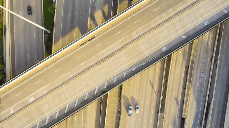An elevated highway spans several lanes below.