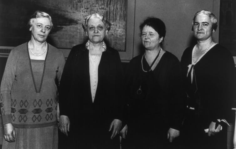 Four smartly dressed women in a row