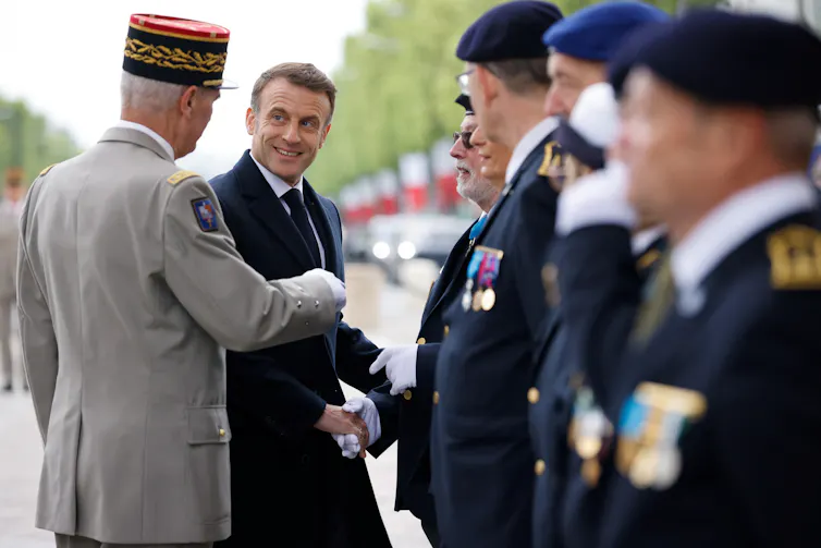 French president, Emmanuel Macron shakes hands with French veterans at a parade to mark the anniversary of the end of WWII in Europe.